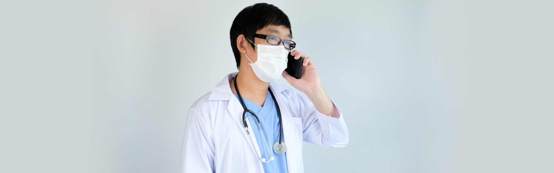 male doctor anwering the phone call
